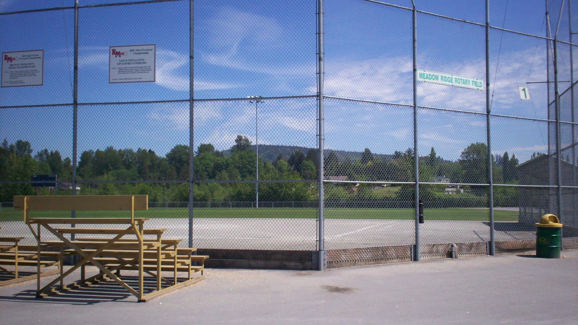 A baseball diamond backstop with bleachers